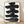 Abstract sumi ink brush strokes in black and charcoal on white, a minimalist calligraphy study with bold, contemplative marks framed on a wall.