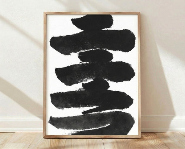 Abstract sumi ink brush strokes in black and charcoal on white, a minimalist calligraphy study with bold, contemplative marks framed on a wall.