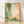 Abstract pointillist wall art in forest green, coral, and golden yellow tones creating a serene, meditative composition with minimalist modern aesthetic.