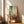 Modern minimalist poster with delicate dotted brushwork in forest green, golden yellow, and coral on a cream background, evoking peaceful contemplation.