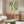 Minimalist abstract print in black, golden yellow, and muted coral stripes displayed framed on wall with contemporary meditative mood.