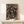 Framed abstract drip composition in warm rust tones and deep black with cream base, modern energetic wall art.