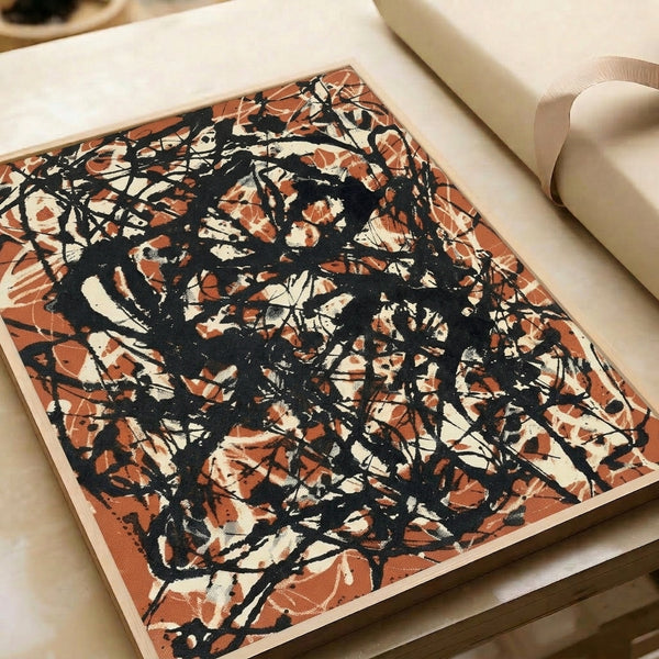 Abstract contemporary poster with burnt orange and black gestural drips on tan-cream ground, bold dynamic composition framed on wall.