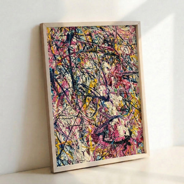 Energetic abstract splatter design in pink, yellow, and blue tones with black marks on a light cream base, presented as a framed contemporary art print.