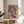 Contemporary abstract splatter poster blending warm pink and yellow hues with cool blue accents and black details against a neutral cream backdrop.