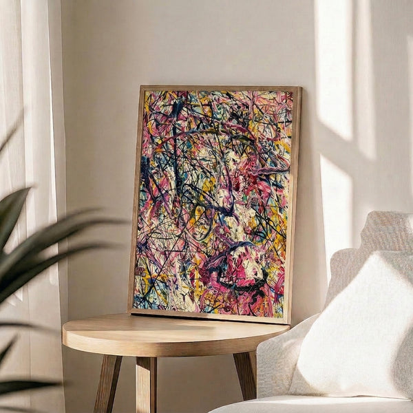 Contemporary abstract splatter poster blending warm pink and yellow hues with cool blue accents and black details against a neutral cream backdrop.
