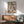 Framed modern abstract expressionist print with expressive gestural brushwork in a vibrant palette of cream, blue, orange, green, and black tones.