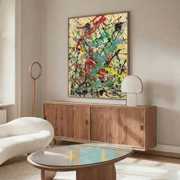 Contemporary abstract splatter art displaying dynamic energy through vivid color layering of red, teal, yellow, and black on cream.