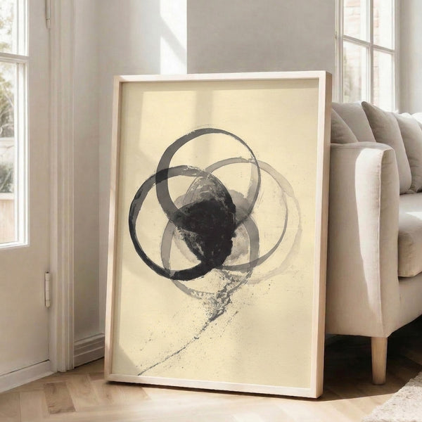Framed abstract print featuring geometric circles rendered in soft charcoal and cream, capturing a serene, minimalist approach to modern wall decor.