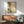 Minimalist abstract poster in muted sage and warm coral hues with subtle yellow touches, conveying tranquil organic movement across a neutral backdrop.