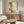 Contemporary wall art combining pointillist technique with abstract forms in complementary greens and coral tones on cream, expressing peaceful contemplative mood.
