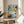 Modern urban art print with energetic spray paint strokes, abstract line work, and barcode motif in contrasting blues and warm orange tones, displayed as framed wall art.