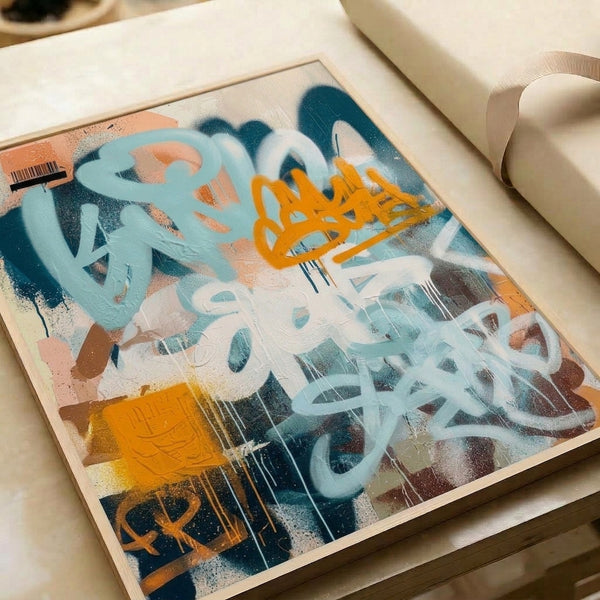 Framed abstract spray art print featuring urban graffiti aesthetics with geometric forms, barcode elements, and energetic brushwork in white, orange, teal, and light blue.