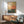 Contemporary geometric poster in cream, terracotta, and navy with sage green and gold details, showing an abstract pixelated gradient that balances modern minimalism with meditative calm.