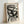Mysterious abstract figure rendered in black ink with experimental line work and bold eyes, contemporary art print on beige.