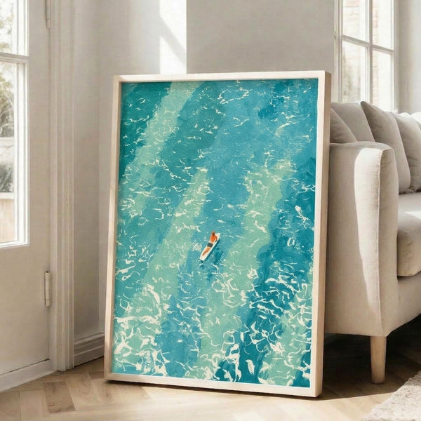 Serene aerial view watercolor art print showing a surfer on turquoise ocean waters with a modern minimalist design in soft coral, cream, and white hues.
