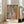 Impressionist poster art with a woman in warm ochre and pale blue tones, conveying quiet domestic elegance and the sensuality of classical bathing imagery.