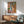 Art print wall hanging showing a woman drying her neck in a moment of quiet solitude, painted with delicate impressionistic brushstrokes and a harmonious palette of warm neutrals.
