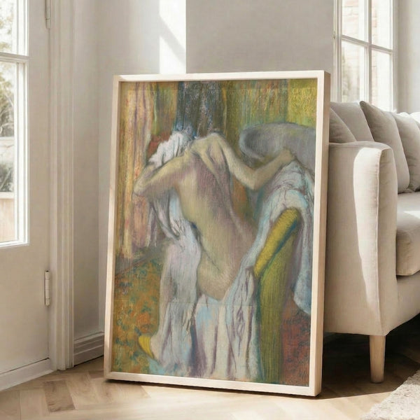 Impressionist poster art displaying a woman in a contemplative pose after bathing, rendered in soft yellows, blues, and naturalistic flesh tones on gallery wall.