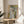 Wall-mounted art print of a woman drying herself in loose impressionist brushwork, dominated by soft ochres, cream, and slate blue tones suggesting candlelit intimacy.