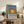 Contemporary minimalist poster of concentric colored squares in teal, periwinkle, rust orange, and gold; sophisticated geometric wall art.