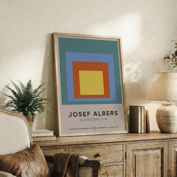 Contemporary minimalist poster of concentric colored squares in teal, periwinkle, rust orange, and gold; sophisticated geometric wall art.