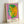 Iconic pop art portrait with vivid pink and green hues and bold black outlines, displayed as a framed wall art print in modern aesthetic.