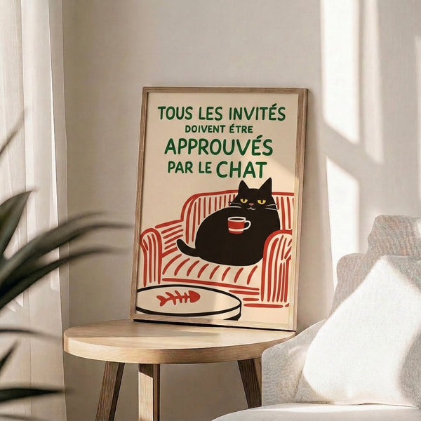 Vintage-styled framed print featuring a charming black cat surrounded by a chair, coffee, and fishbowl in creams, forest greens, and warm accent colors with whimsical art nouveau elements.