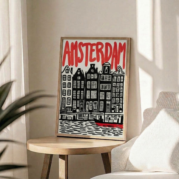 Graphic travel poster with bold red and black linework showing Amsterdam's characteristic canal buildings and boat, rendered in a nostalgic vintage style on a light cream ground.