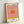 Pop art sunset artwork in vibrant golden yellow and rose pink with minimalist design, evoking a serene and warm aesthetic on a cream field.