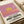 Pop art exhibition print capturing a luminous sunset sun in mauve pink and golden tones, minimalist composition evoking quiet contemplation.
