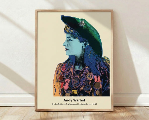 Bold pop art portrait of Annie Oakley in vibrant reds, yellows, and blues with black outlines, framed poster celebrating the iconic sharpshooter from the Cowboys and Indians series.