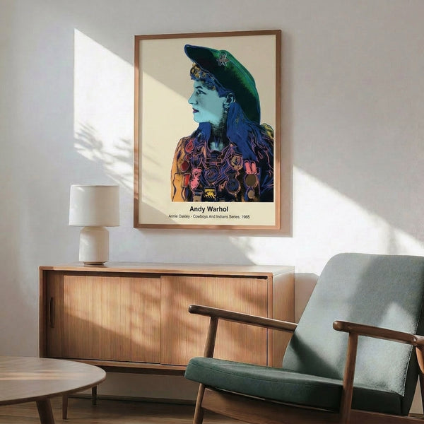 Framed pop art print of Annie Oakley featuring striking color-block imagery in primary colors and black, celebrating Western culture with 1960s retro flair.