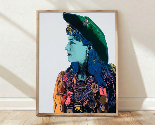 Framed pop art poster of Annie Oakley in vibrant colors, featuring bold graphic portrait style characteristic of 1960s Warhol artwork from the Cowboys and Indians series.