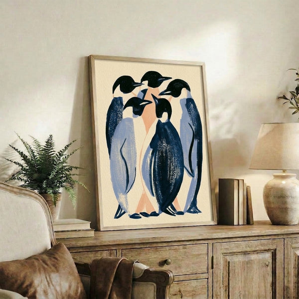 Framed minimalist penguin artwork in sophisticated Art Deco design with composed figures rendered in cream, peach, navy, and gold tones.