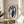 Elegant Art Deco poster of huddled penguins rendered in muted periwinkle, navy, cream, and peach with gold details for contemporary wall decor.