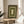 Ornate vintage botanical wall art displaying symmetrical Art Nouveau floral and leaf designs in forest green, brown, and cream palette.