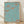 Art Nouveau botanical poster with stylized clover and leaf motifs in turquoise, terracotta, and cream tones, framed on a wall.
