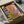 Nature-inspired retro flower print displaying stylized daisies in vibrant orange and purple tones with cream ground and organic art nouveau details, displayed framed.