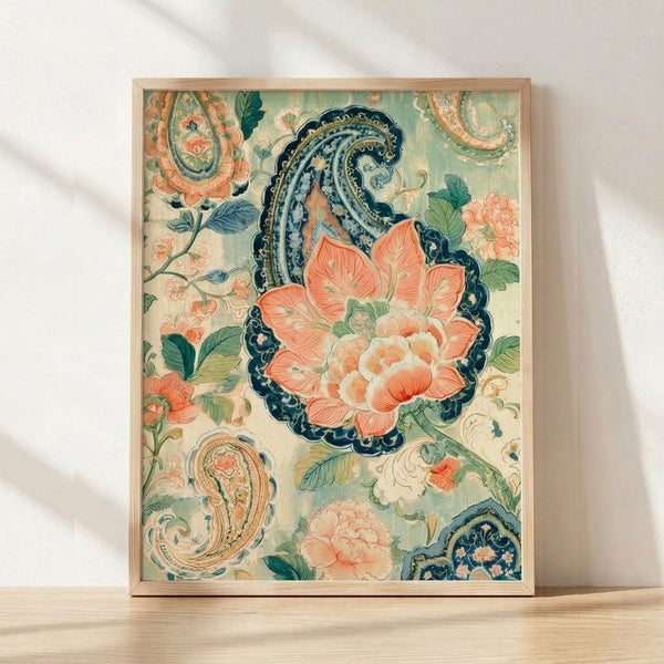 Ornate Art Nouveau peony and paisley botanical print in coral orange, sage green, and navy blue with gold accents on cream background, framed on wall.