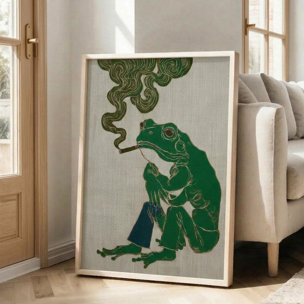 Vintage-style framed art print of a whimsical frog wearing a ornate robe and smoking a pipe, combining elegant line work with muted greens, cream, and gold tones in an Art Nouveau aesthetic.