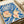 Art Nouveau wall art depicting an elegant seashell surrounded by ornamental flora rendered in ethereal watercolor with cobalt blue, cream, and blush tones.