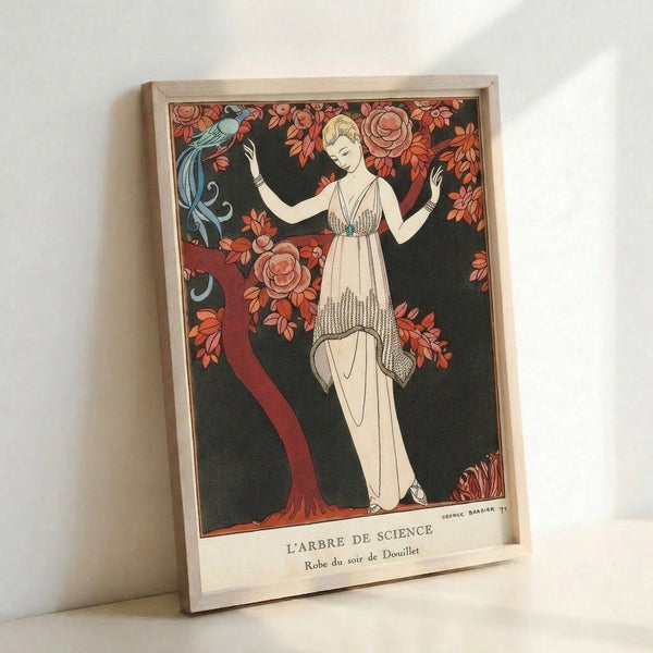Framed Art Nouveau artwork showing an elegant figure in an ornate dress near a flowering tree with a bird, executed in soft cream and deep black with coral and rust accents.