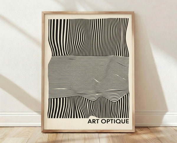 Black and cream kinetic abstract lines create an optical illusion pattern on a framed minimalist art print hung on a wall.