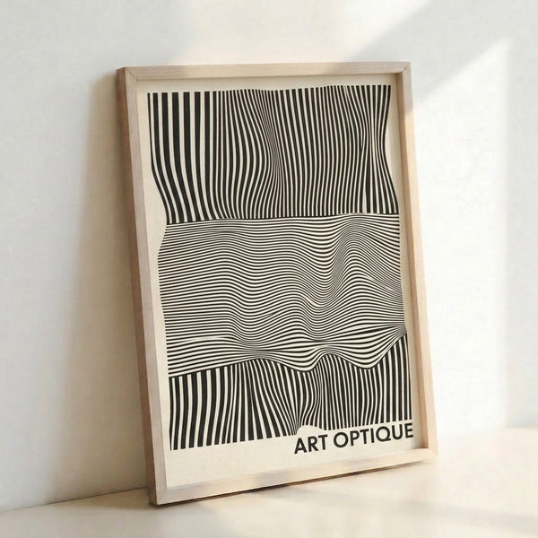 Minimalist framed wall art featuring interlocking black lines and cream tones that create a mesmerizing optical effect.