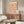Decorative Art Nouveau floral print featuring stylized botanical motifs in a repeating pattern with warm, earthy terracotta tones.
