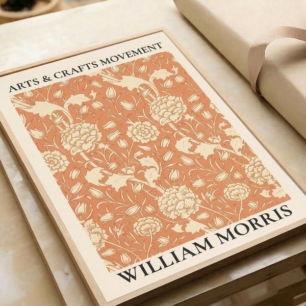 Framed vintage botanical artwork in the Arts and Crafts style, displaying ornamental flowers and leaves with elegant warm color tones.