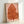 Abstract botanical ink drawing of a solitary leaf in warm rust hues with flowing, deliberate strokes on neutral canvas, embodying calm wabi sabi design.