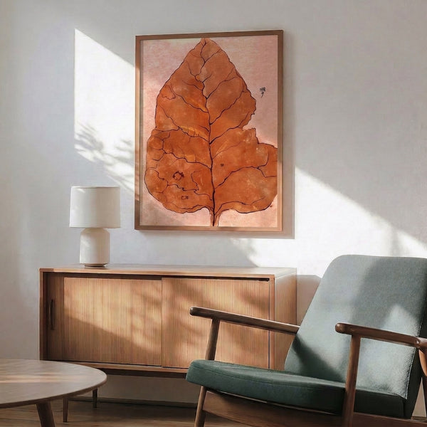 Framed wabi sabi botanical print depicting an elegant leaf in warm autumn tones through understated watercolor and ink techniques on cream ground.