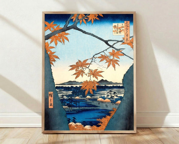 Serene Japanese woodblock print featuring autumn maple leaves and branches in orange and cream tones, with a misty mountain landscape and water below rendered in deep blue and teal.